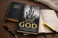 The book "Stop, in the Name of God" laying on a table with a Bible and notebook.