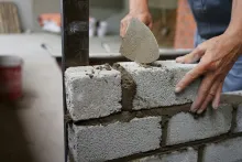 Brick wall being built with mortar