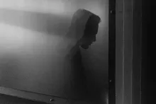 Shadow of a man against a gray wall