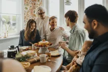 People sitting around a table eating.