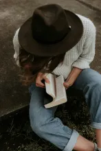 A woman opening a Bible.