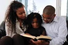 A family reading a Bible together.