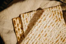 three matzos sitting atop a piece of cloth