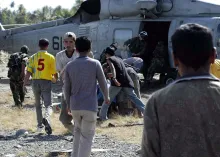 An air crewman, assigned to the "Golden Falcons" of Helicopter Anti-Submarine Squadron Two (HS-2), unload food and water from a SH-60F Seahawk, in Aceh Jaya, Sumatra, Indonesia.