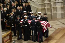 The casket of President Gerald R. Ford is carried past a group that includes President George W. Bush, first lady Laura Bush and Presidents George Bush Sr., Bill Clinton and Jimmy Carter at the National Cathedral in Washington Jan 2, 2007.