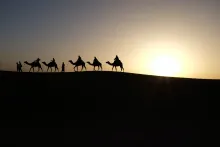 Men riding on camels.