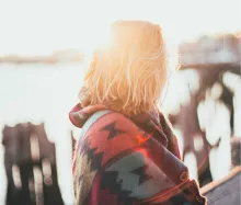 A woman with sunlight behind her.