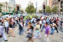 A blur of people walking in a busy city.