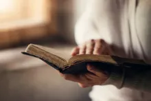 A woman holding a Bible.