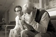 A doctor consoling a person who is grieving.