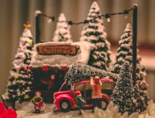 A miniature Christmas scene of gathering a Christmas tree.