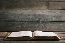 An open Bible laying on a table.