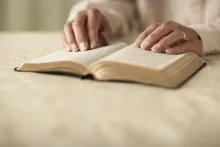 A woman reading a Bible.