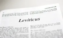 A Bible opened to the beginning of the book of Leviticus.