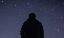 A young person looking up at the stars.