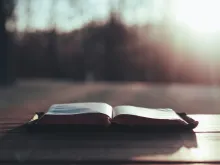 An open Bible on a table.