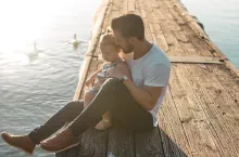 A dad sitting with his daughter.