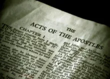 Page of the Bible opened to Acts.