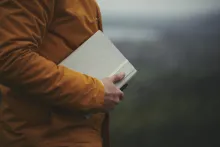 A man holding a journal notebook.