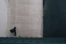 A man walking alone on a sidewalk.