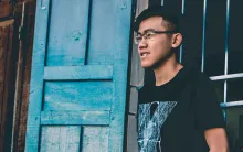 A young man standing by himself.