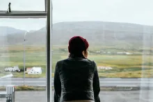 A woman looking out a window.