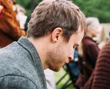 A man with his head down appearing to be grieving.