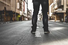 A person standing in the middle of a road.