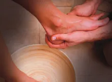A person washing another person's foot.