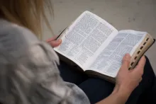 A woman reading a Bible.