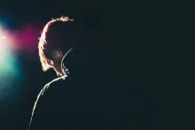 A young man with his head down.