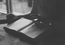 A woman reading a Bible.