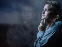 A woman looking out a window.
