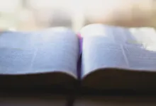 An open Bible laying on a table.