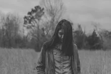 A woman walking in a field.