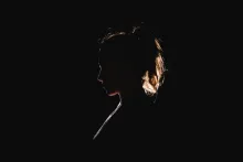 A silhouette of a young woman.
