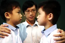 Two boys angrily looking at each other.