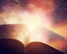 An open book/Bible with light around it.