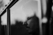 A man looking through a window.