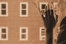 A woman hand against a window.