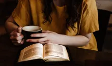 A woman reading a Bible.