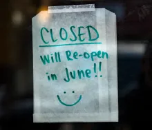 A handwritten note on business store door that its closed till June.