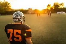 Football player on field at sunset