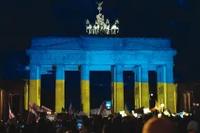 German protestors demonstrate in solidarity with Ukraine in front of the famous Brandenberg gate in Berlin, which is bathed in the colors of the Ukrainian flag.
