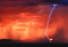 A storm with clouds, rain and lightning.
