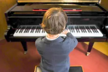 a boy playing a piano