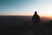 A person standing at the top of the Grand Canyon.