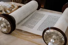 a Hebrew scroll rolled partially open to reveal text