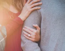 a woman's arm linked through a man's arm