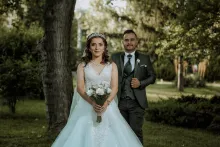 a bride and a groom walking outside